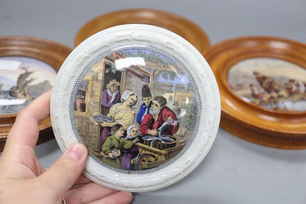 Three Prattware pot lids in oak frames and another Prattware pot